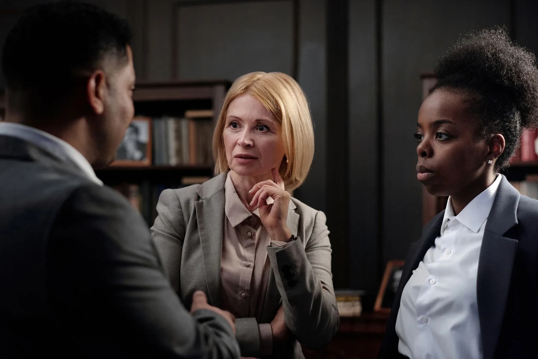 Public service professionals discussing a case in a formal office
